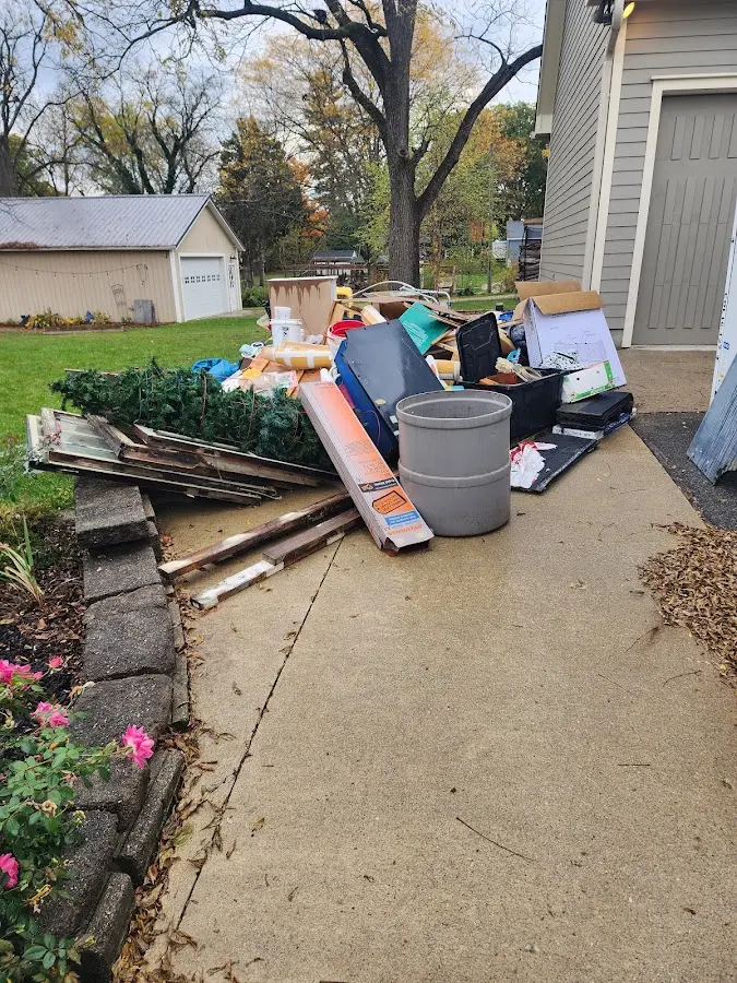 Dumpster being loaded with debris for 12 Yard Dumpster Rental in Royersford